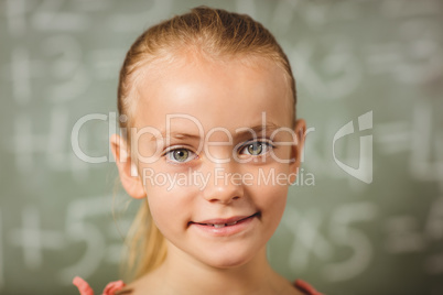 Girl standing in front of blackboard