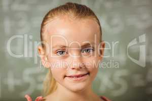 Girl standing in front of blackboard