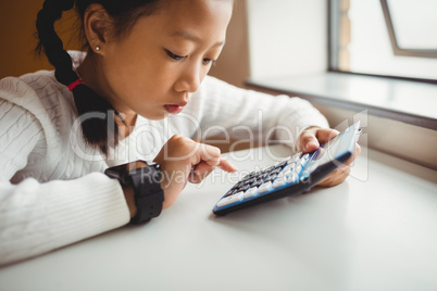 Schoolchild using a calculator