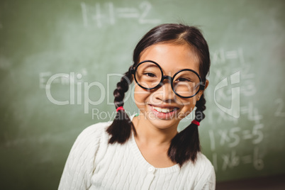 Girl standing in front of blackboard