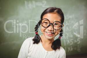 Girl standing in front of blackboard