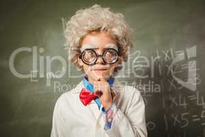 Boy standing in front of blackboard