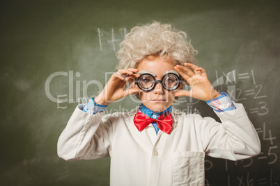 Boy standing in front of blackboard