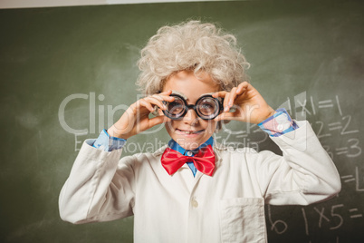 Boy standing in front of blackboard