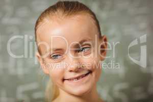 Girl standing in front of blackboard