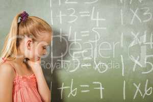 Girl standing in front of blackboard