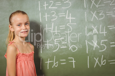 Girl standing in front of blackboard