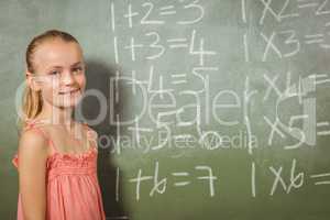 Girl standing in front of blackboard