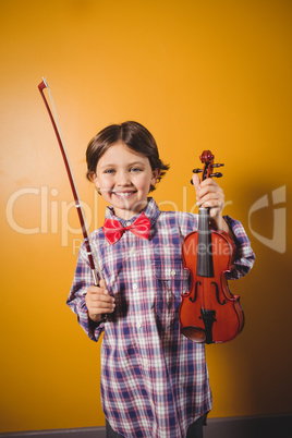 A little boy holding a violin