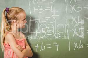 Girl standing in front of blackboard