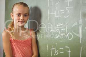 Girl standing in front of blackboard