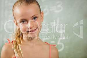 Girl standing in front of blackboard