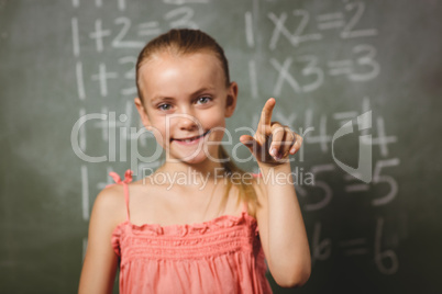 Girl standing in front of blackboard