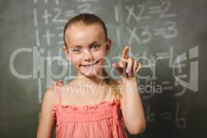 Girl standing in front of blackboard