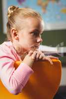 Girl leaning against chair