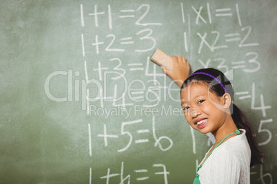 Girl using a sponge for blackboard