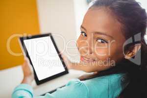 Girl smiling and using a tablet