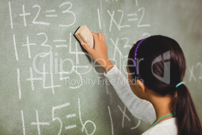 Girl using a sponge for blackboard