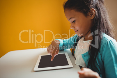 A little girl using a tablet