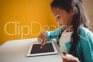 A little girl using a tablet