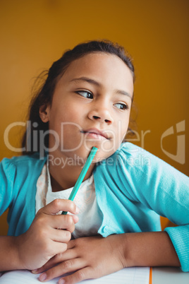 Thoughtful girl sitting at a desk