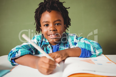 Boy writing in his notebook
