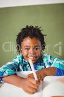 Boy writing in his notebook