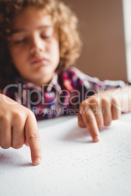 Boy using braille to read