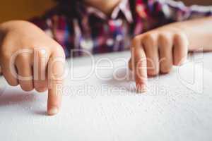 Boy using braille to read