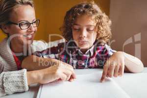 Boy using braille to read