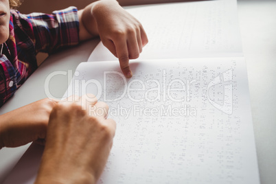 Boy using braille to read