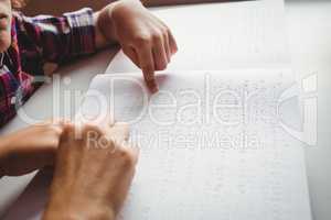 Boy using braille to read