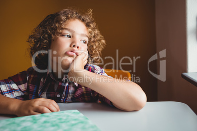 Boy sitting down on his chair and dreaming