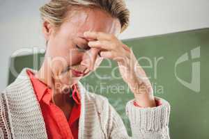 Sad teacher in front of blackboard