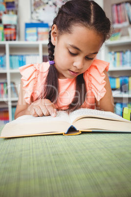 Close up of little girl reading a book