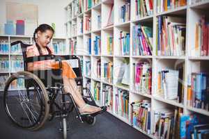 Girl in a wheelchair reading a book