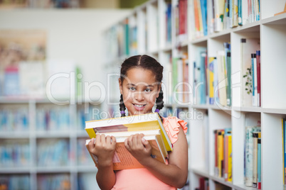 Smiling girl holding books