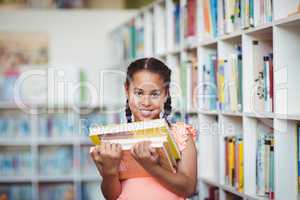 Smiling girl holding books