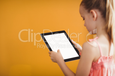 Rear view of girl using a tablet