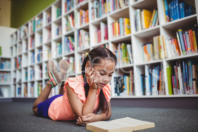 Girl lying and reading a book