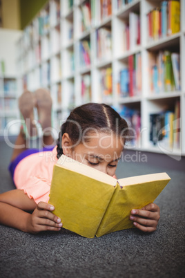 Girl lying and reading a book