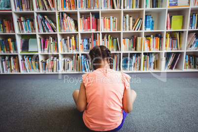 Rear view of girl reading a book