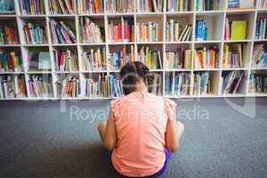 Rear view of girl reading a book