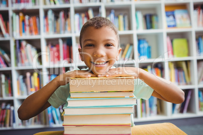 Boy putting his head on books
