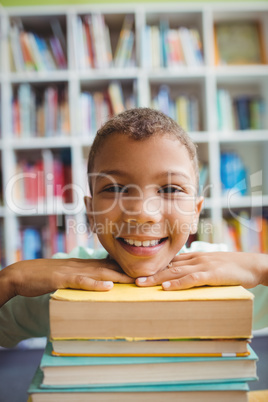 Boy putting his head on books