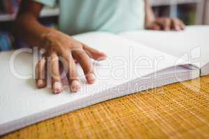 Boy using braille to read