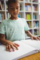 Boy using braille to read