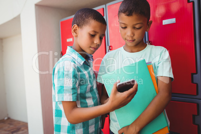 Boys with smartphone in the corridor