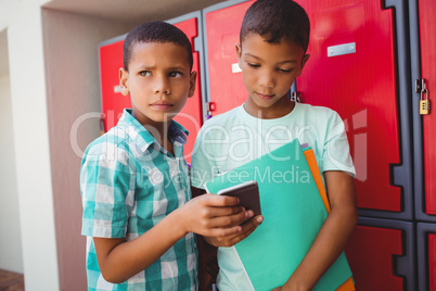 Boys with smartphone in the corridor