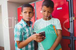 Boys with smartphone in the corridor